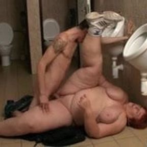 Enormous woman takes it in the restroom