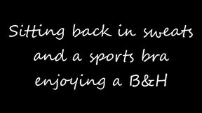 Sitting back in sweats and a sports bra smoking B&H