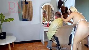 Nudist barbershop. Nude lady hairdresser in an apron. The client is surprised. Cam 1