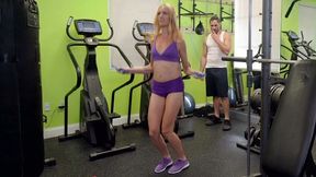 Slender blonde in sexy XXX outfit seductively moves in gym near guy