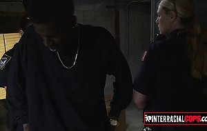 Redhead cop arrest a black dude to get him fucked by her partner at a warehouse in the hood for fun