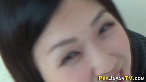 Asian pees into glass box as voyeur watches
