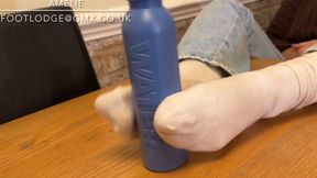 Playing with a water bottle using just my feet in dirty white socks