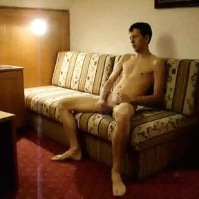 Naked twink strokes his cock in a hotel room