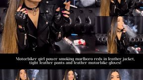 Motorbiker girl power smoking marlboro reds in leather jacket, tight leather pants and leather motorbike gloves!