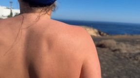 Girl is walking on the public beach and pee