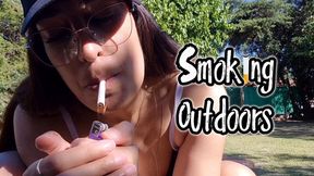 Alesia in a bikini, smoking sexily outdoors