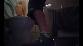 Sporty guy peeing at home