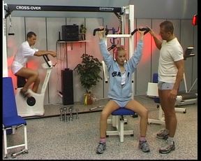 Petite blonde German babe rides two dicks in the gym