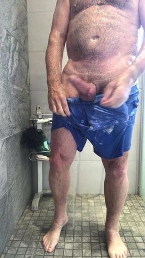 soapy shower in thin blue shorts