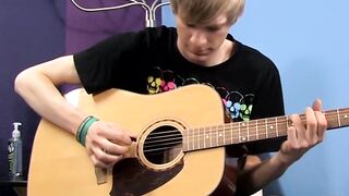 Young man plays guitar before dick stroking and cumming