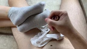 The girl did a footjob in socks and then took off her panties and was allowed to cum on them