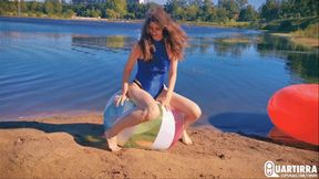 Q906 Cosette rides and deflates big beachball on a lake - 480p