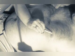 This guy smokes a cigarette and licks his lover's teats