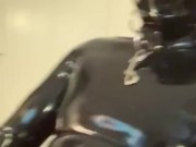 Gagged rubber gimp jerks off