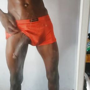 Tall sexy African man with a very big black cock rubs his cock in  front of a mirror home alone