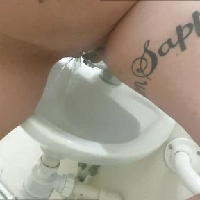 Pissing in the work sink and playing with it