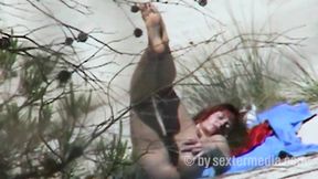 Redhead beauty dildoing pussy on the sandy beach