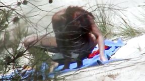 Redhead beauty dildoing pussy on the sandy beach