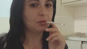 Brunette in black enjoying a cigarette