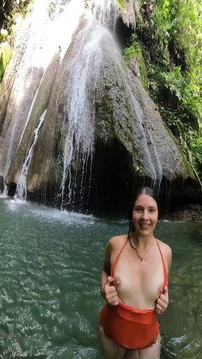 Woman in bikini near waterfall