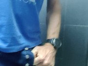 Locked in a chastity cage, man is pissing in a public toilet