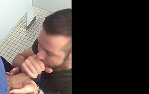 Handsome guy sucks dick in restroom stall