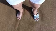 Feet and the sea extra slowmotion - one foot barefoot and foot in slide - great feet in sea