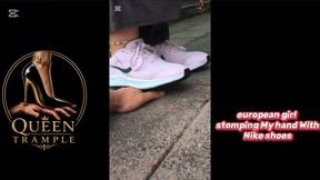 Girl stomping My hand With pink sneakers