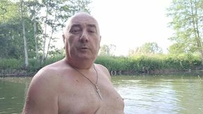 The plump, mustachioed daddy is having a blast in the stream, shamelessly masturbating with mud