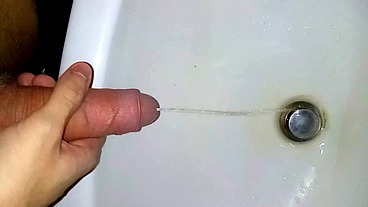 Taking a huge leak in the sink