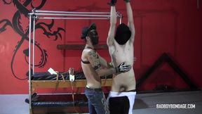 Masked Damien is tied and flagellated by master Ryann