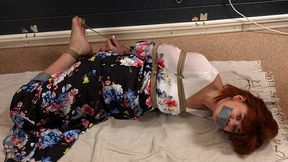Tapegagged barefoot redhead Kathy in long flower dress, hogtied with her big toes tied, is getting her feet oiled and tickled (HD WMV)