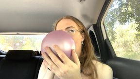 Cute girl fearlessly blows and pops 5 balloons in the back of your car