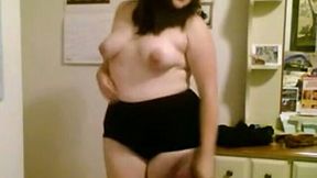 Chubby geek chick gets naked in her room and caresses her fat body