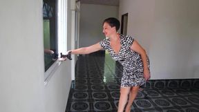 Nice woman shows her body when undressing from white-black dress.