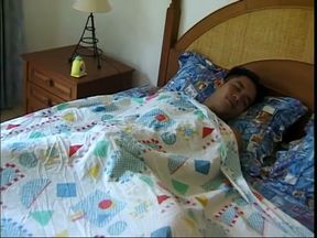 Horny Thai strokes his hard cock in bed