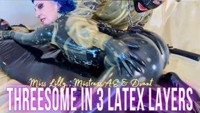 Miss Lilly and Mistress AE have a Threesome with their rubber toy in three layers of latex