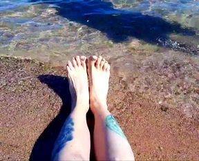 Dominatrix Nika enjoys the salty sea on her feet.