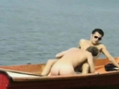 Two gorgeous gay studs satisfying their desires and needs on a boat