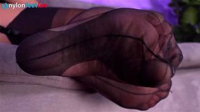Sexy girl in stripped stockings pokes her feet your face