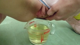 pee in measuring cup | close up