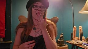 Smoking while wearing a purple corset, gloves, and a hat
