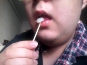 Gay teen licks and eats a lollipop made of his own cum