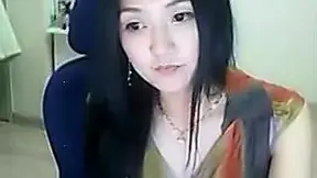 Adorable Asian Darling smokes cigarette and demonstrates her boobs