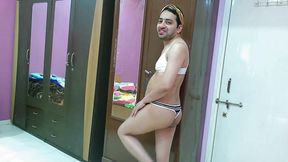 Sexy sissy crossdresser femboy Sweet Lollipop in a bra-thong, hairband and flip-flops.