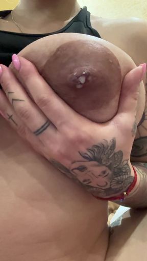 Lactating milf shows off her tits while feeding baby