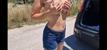 A Woman Undresses in the Middle of the Road and Walks Naked Down the Street