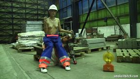 Skinny blonde worker in the factory takes her break for a cigar