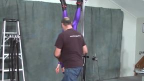 suspended in purple catsuit